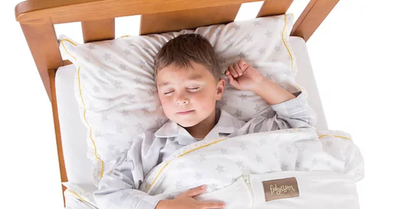 image of a young boy sleeping in a bed, wrapped up in compression bedding - fidgetbum