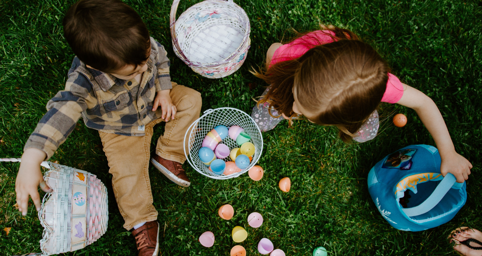 Overhead image of a boy and girl collecting Easter eggs in baskets