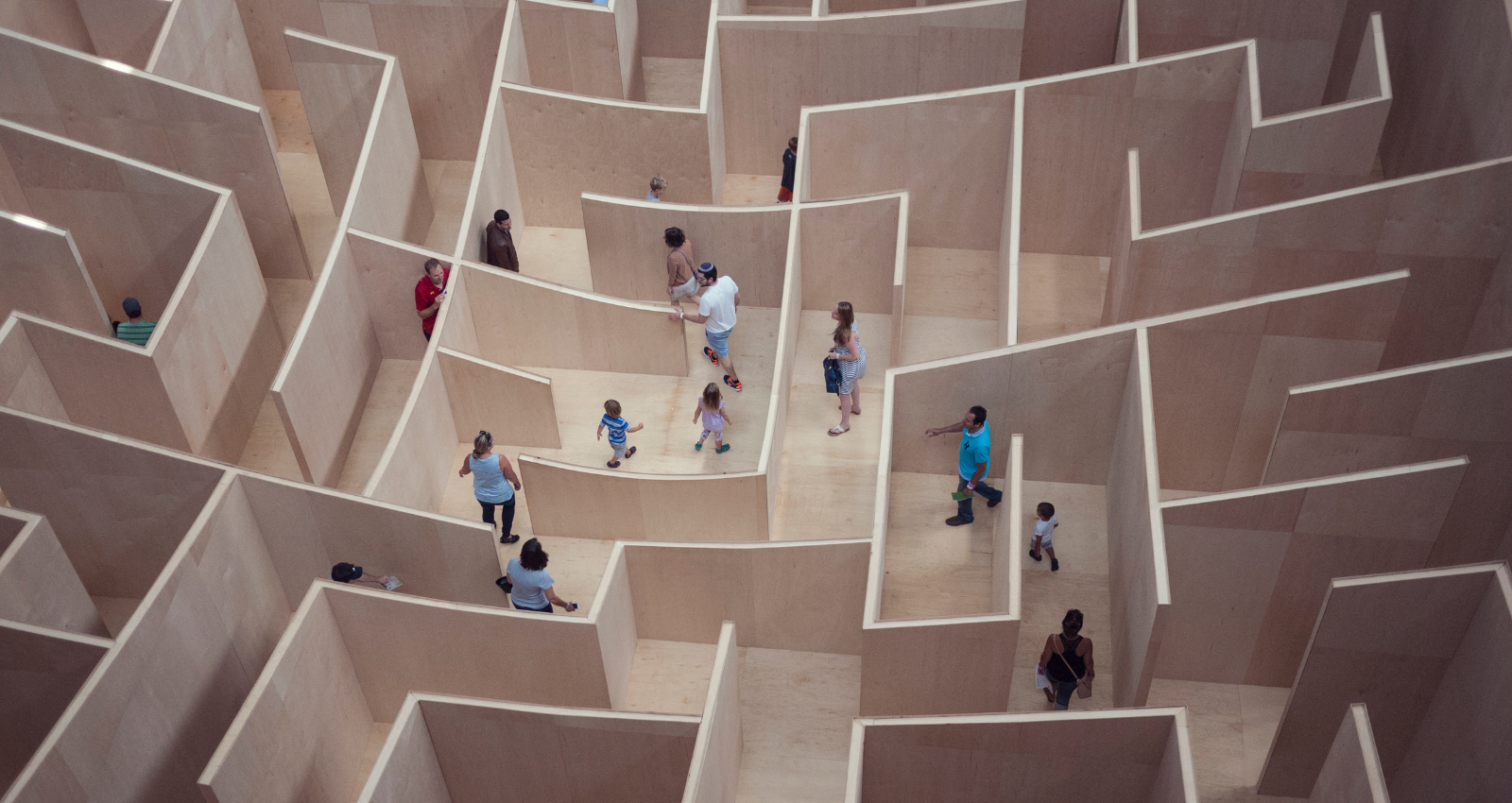 people walking around a large maze